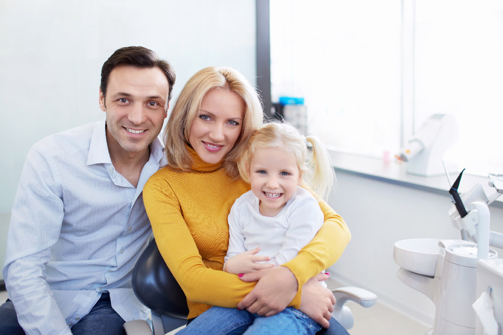 Smiling family at dental appointment